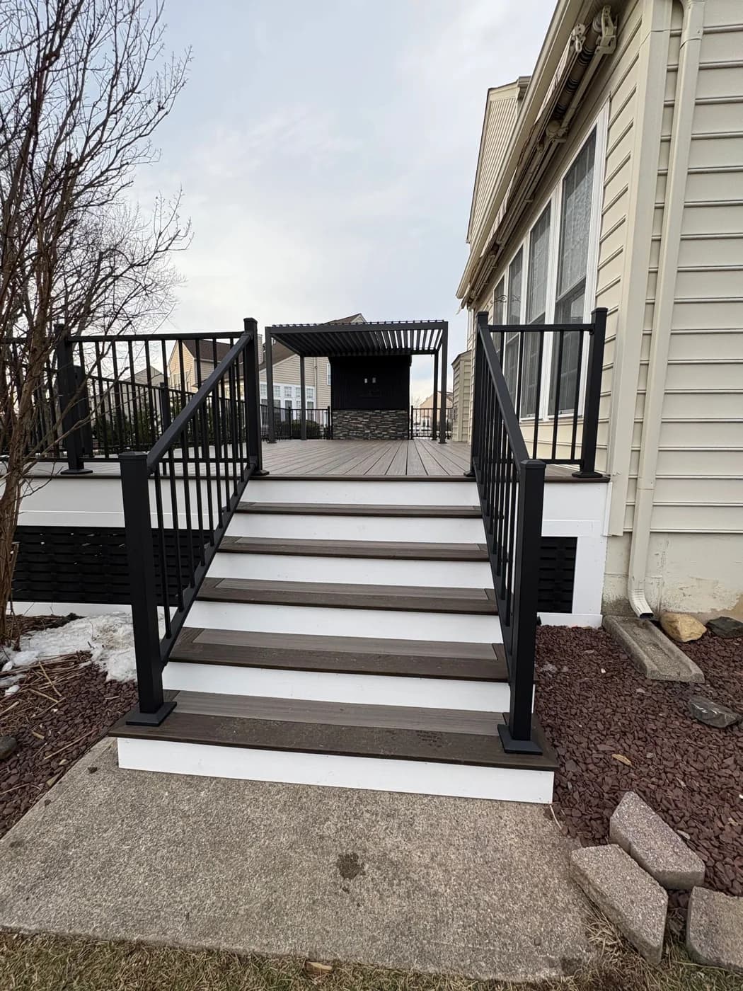 Deck staircase with black railings and contrasting white risers