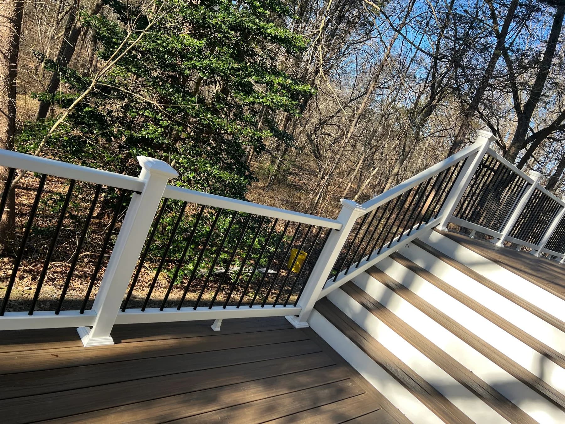 White-railed stairs connecting the upper and lower deck surfaces