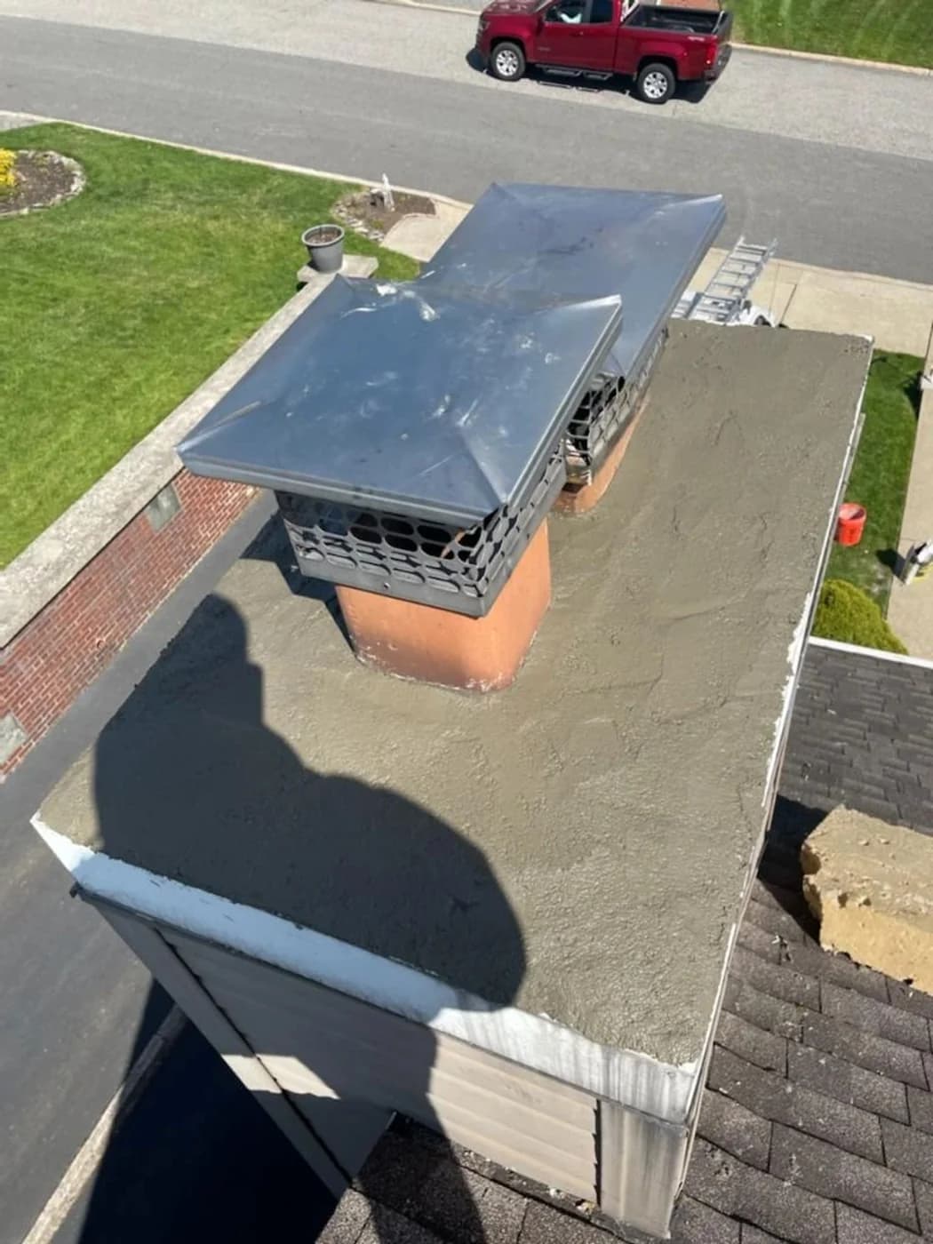 Restored gray crown surface around the chimney’s capped clay flues